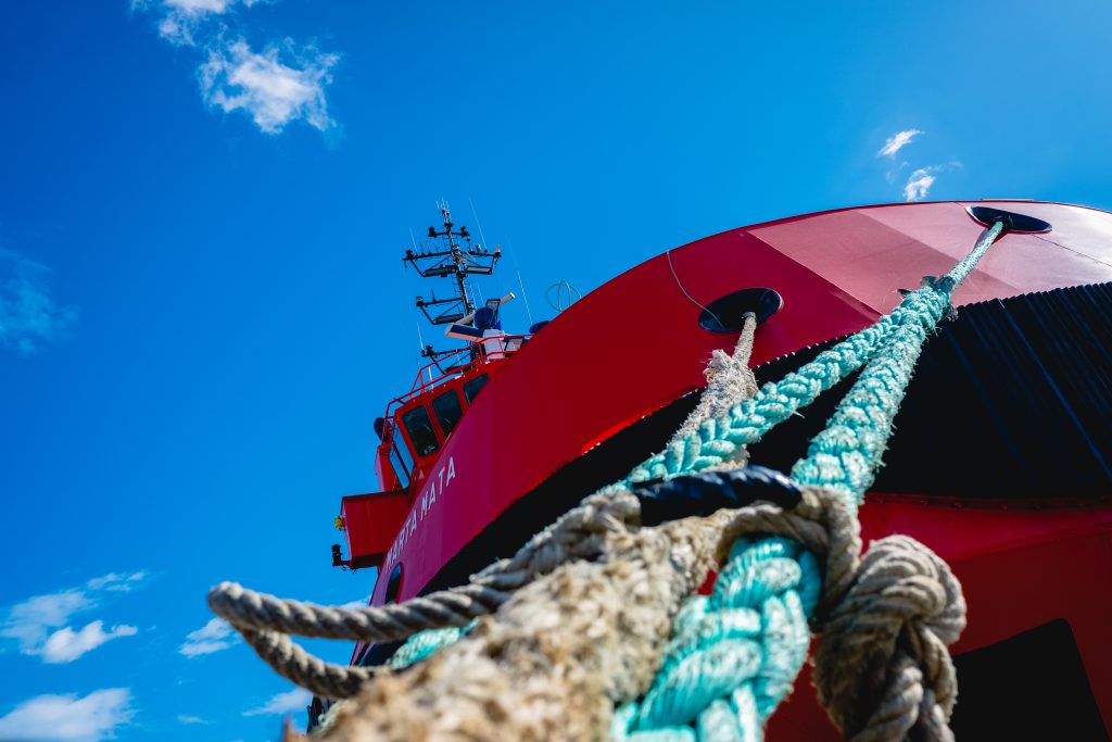 Valencia, Spain. Red rescue ship moored to port, seen from the mooring.